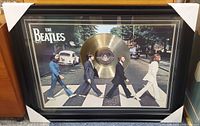 Full view of framed Abbey Road gold record display with protective corners
