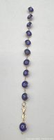 Full view of bracelet showing sequence of evil eye beads and clasp