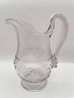 Full side view showing overall form, handle, spout and foot