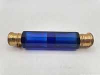 Full view of cobalt blue double ended bottle showing both brass caps attached