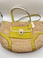 Full view of the Coach straw and leather shoulder bag showing entire design and condition