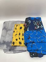 All three folded scarves showing colours and patterns