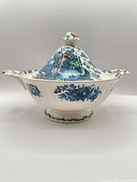 Side view of covered tureen showing pattern, handles and finial