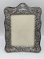 Front view of ornate silver-plated picture frame