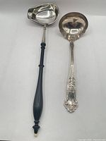Both ladles side by side showing full length and design differences