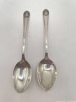Full view of both sterling spoons