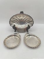 All three silver-plated shell trays, large on stand, two small below