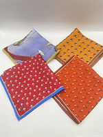 All four pocket squares folded, showing patterns and colors
