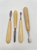 Full set of four manicure tools, showing handles and tips