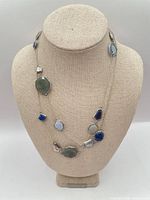 Full view of necklace on display bust showing overall design and stone arrangement