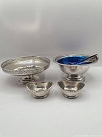 Group view of all silver-plate items and liner