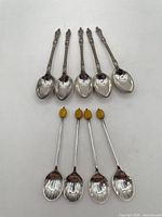 Group of nine spoons, two styles displayed