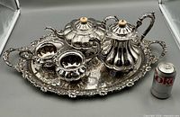 Full set arranged on tray beside soda can for scale