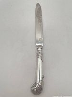 Full view of silver plate cake cutter