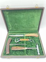 Open case showing all four tools in green velvet interior