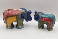 Front view of both raku pottery elephant figurines