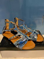 Full view of both sandals on box