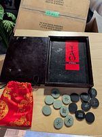 Open wooden box with interior label, stones and pouch displayed