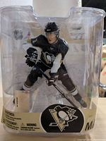 Front view of sealed Evgeni Malkin action figure in packaging
