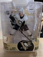 Front view of sealed Evgeni Malkin action figure in packaging