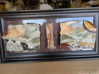 full view of framed ceramic art piece