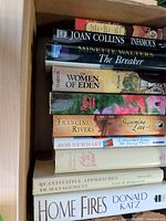 Stack of ten hardcover books showing spines and titles