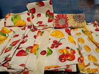 Group of fruit print towels spread out