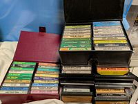 Two open plastic cassette cases showing large quantity of tapes