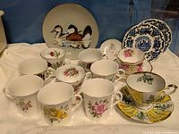 Front view showing assorted mugs, teacups, saucers and plates