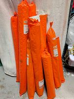 Group shot showing nine orange-wrapped Clearprint vellum rolls