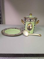 Jar, saucer and spoon grouped to show full set