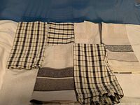 All six folded cotton kitchen towels displayed together, showing variety of check and jacquard patterns
