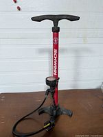 Full view of Schwinn red floor pump standing on table