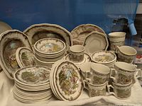 Full set displayed showing quantity and variety of plates, bowls, cups and serving pieces