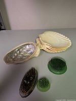 All items together: abalone shell, scallop shells, three floral frogs