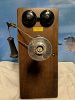 Front view showing full telephone with bells, mouthpiece, receiver, and crank
