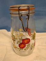 Full view of jar showing bail clasp, lid, graphics