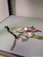 All seven watches laid out on surface