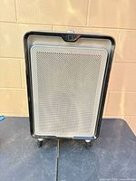 Front view of Bissell air220 air purifier showing perforated grille and overall condition