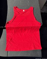 Red tank top laid flat displaying full front