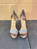 Front view showing open toe, perforated toe strap, ankle strap design