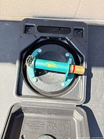 Vacuum cup seated in open case showing handle, pump and pad