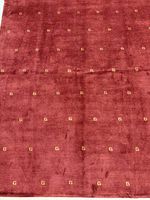 Full view of rich red rug with gold G motifs