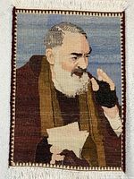 Full view of handmade wool portrait tapestry with fringe