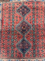 Full view of Persian Shiraz rug showing overall pattern and borders
