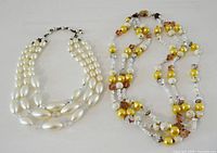 Both necklaces laid flat showing full designs