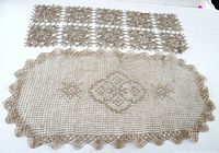 Both crocheted runners laid flat showing full designs