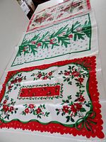 All three tea towels laid out showing patterns