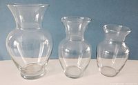Front view of three clear glass vases side by side