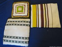Front view of three pillows showing patterns and colours